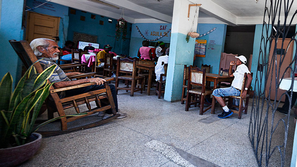 Open air cafe in downtown Havana where patrons can view state run TV; there's no satellite here